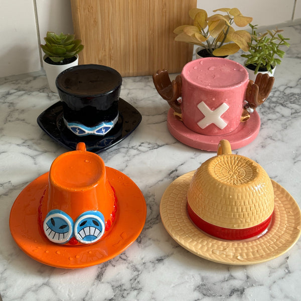 Sabo, Chopper, Ace and Luffy hat mugs on a kitchen counter